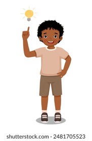 Cute little African boy got an idea pointing finger up with bulb light