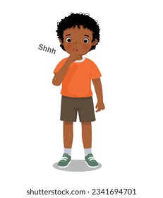 Cute little African boy making silence gesture putting his finger on lip asking to be quiet