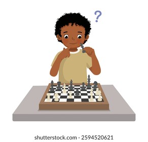 Cute little African boy playing chess thinking on the strategy for next move