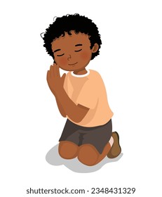 Cute little African boy praying kneeling on his knee