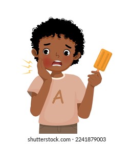 Cute little African boy with sensitive teeth having toothache while eating cold ice cream touching his cheek feel painful