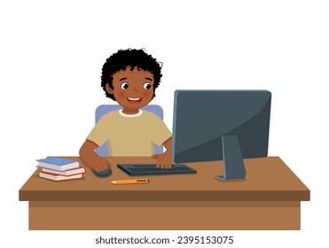 Cute little African boy student study using Computer PC at the desk