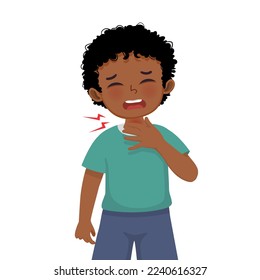 Cute little African boy suffering from sore throat touching his swelling and painful neck as symptoms of flu and allergy