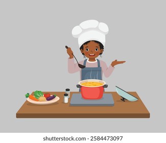 Cute little African girl chef cooking delicious vegetable soup with hand showing for copy space