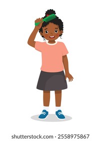 Cute little African girl combing her hair with comb