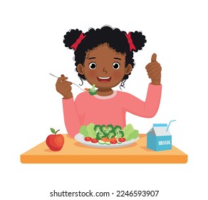 Cute little African girl eating broccoli healthy vegetables with fork showing thumb up gesture