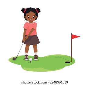 Cute little African girl playing golf ready to hit ball aiming at the hole