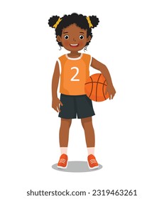 Cute little African girl with sportswear holding basketball with both hand