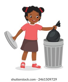 Cute little African girl taking out the trash in garbage bag into recycling bin