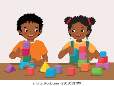 Cute little African kids boy and girl playing colorful wooden brick block toys together at the table