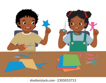 Cute little African kids boy and girl cutting colored paper with scissors making paper cut art craft