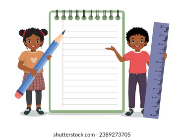 Cute little African kids holding big pencil and ruler standing with big notebook