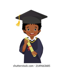 cute little African schoolboy in graduation hat and gown holding diploma certificate 