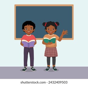 Cute little African students boy and girl holding books standing in front of classroom