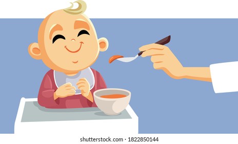 Cute Little Baby Being Fed Using Spoon. Little infant wearing a bib enjoying solid food
