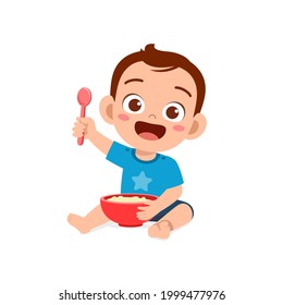 cute little baby boy eat porridge in bowl with spoon