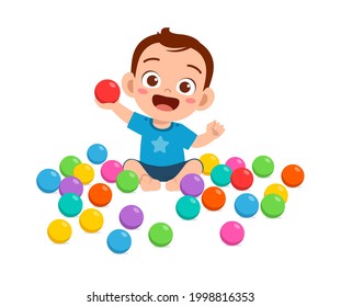 cute little baby boy playing with colorful balls