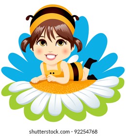 Cute little baby girl with bee costume resting lying down on top of a white daisy smiling happy