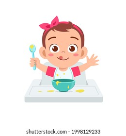 cute little baby girl eat porridge in bowl with spoon