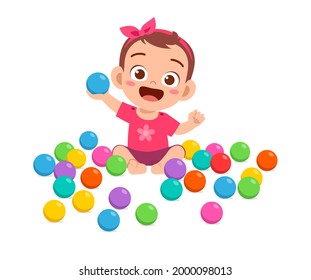 cute little baby girl playing with colorful balls