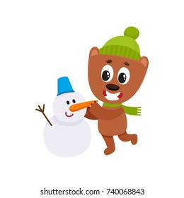 Cute little bear character making a snowman in hat and scarf, winter activity, cartoon vector illustration isolated on white background. Little baby bear animal character making snowman