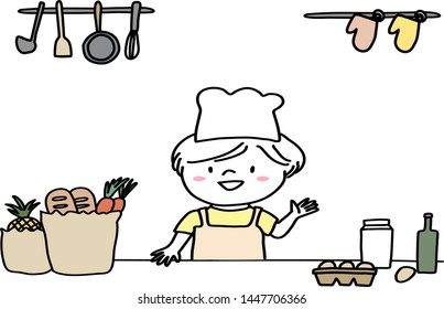 Cute little boy with apron and chef hat standing at kitchen counter. Happy girl in apron cooking in kitchen, standing at counter full of groceries such as eggs, milk, bread, and smiling at the camera.