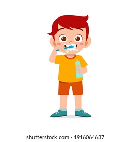 cute little boy brushing teeth and holding toothpaste