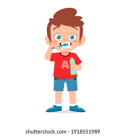 cute little boy brushing teeth and holding toothpaste