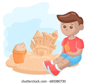Cute little boy is building a sand castle
