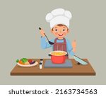 cute little boy chef cooking delicious vegetable soup showing thumb up