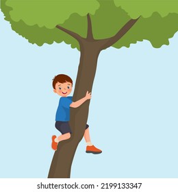 cute little boy climbing big tree in the park