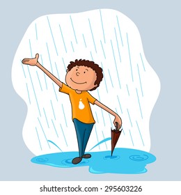Cute little boy with closed umbrella, enjoying in rains for Monsoon Season.