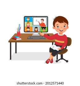 Cute little boy connecting with other school children via teleconference or virtual class online on computer. Study from home concept for student using video conference at homeschooling.