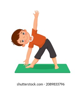 Cute little boy doing gymnastic fitness exercises practicing yoga pose on a mat indoor