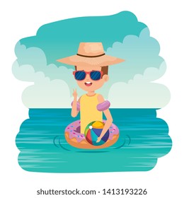 cute little boy with donut float and beach balloon on the sea