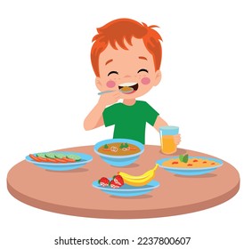 cute little boy eating at the dinner table