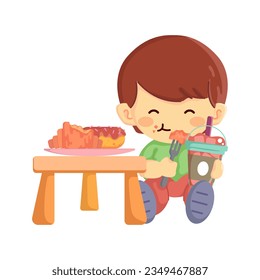 A cute little boy enjoying a pastry or snack with his coffee