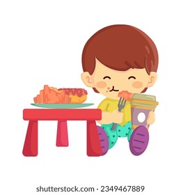 A cute little boy enjoying a pastry or snack with his coffee