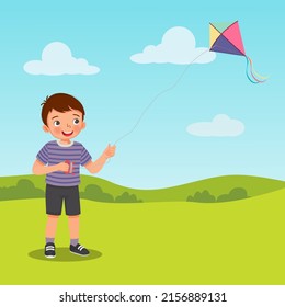 cute little boy enjoying playing kite in the park on summertime