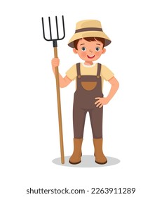 Cute little boy farmer holding a rake working in the farm