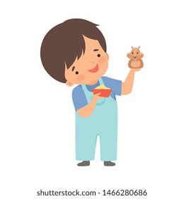 Cute Little Boy Feeding His Hamster, Adorable Kid Caring for Animal Cartoon Vector Illustration