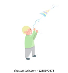 Cute little boy with flying kite isolated on white background. Blonde preschool boy happy smiling and playing with toy kite.