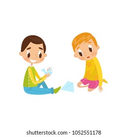 Cute little boy and girl sitting on the floor doing origami crane, education and child development concept vector Illustration