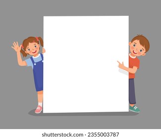 Cute little boy and girl standing behind empty banner peeking and pointing finger over the board waving hand