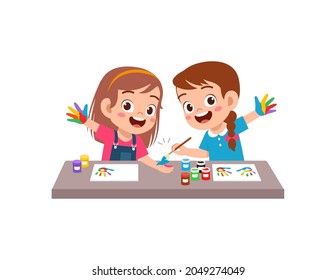 cute little boy and girl using paint to hand for art