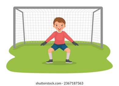 Cute little boy goalkeeper standing in pose at the goal preparing to catch soccer ball