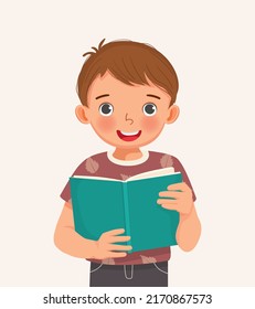 cute little boy holding book reading