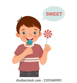 cute little boy holding lollipop candy showing sweet taste of tongue five senses 