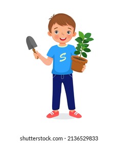 cute little boy holding potted plant and shovel in the garden