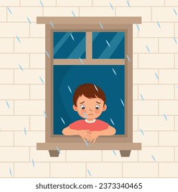 Cute little boy looking at raindrops from window feeling sad can not play outside